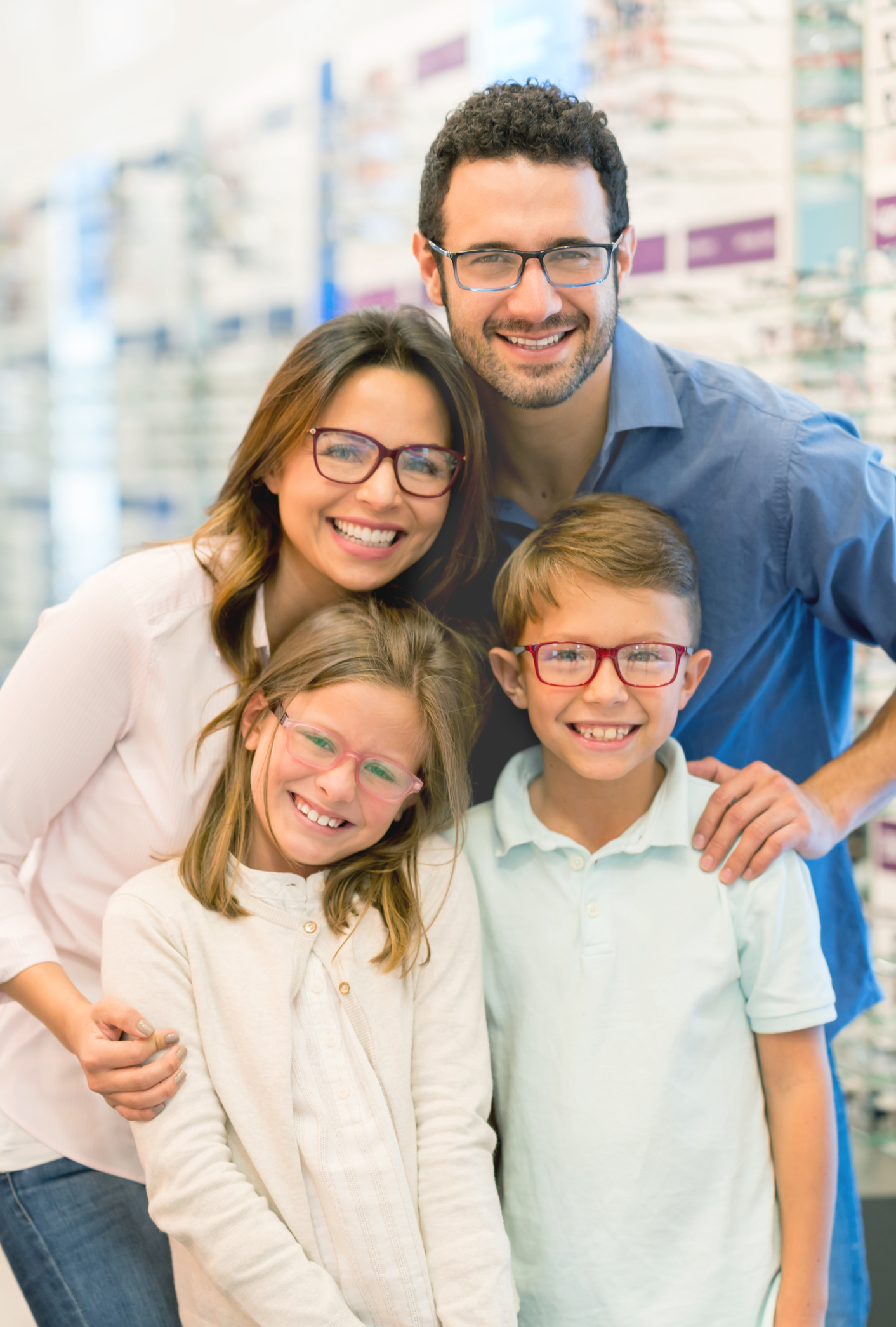 Happy family wearing glasses at the optical shop